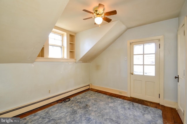 bonus room with lofted ceiling, dark wood-type flooring, built in shelves, ceiling fan, and a baseboard radiator