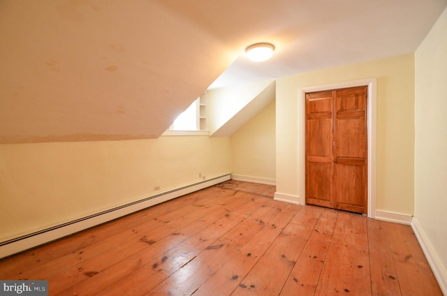 bonus room with baseboard heating and light hardwood / wood-style flooring