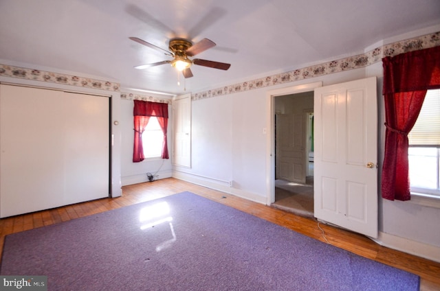 unfurnished bedroom with ceiling fan and light hardwood / wood-style flooring