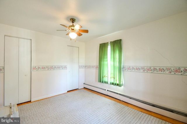 spare room featuring baseboard heating and ceiling fan