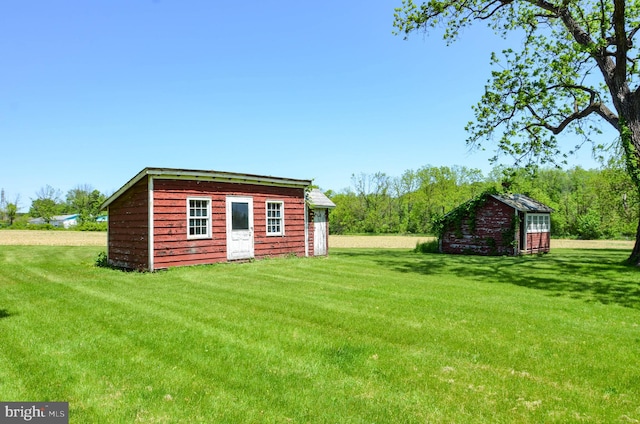 view of outbuilding featuring a yard