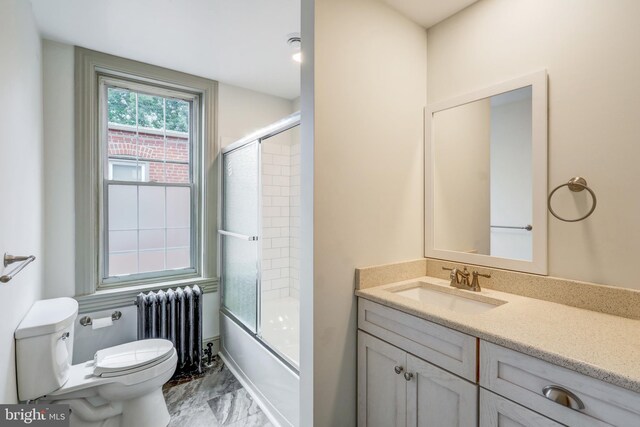 full bathroom featuring vanity, toilet, shower / bath combination with glass door, and radiator