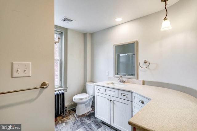 bathroom featuring vanity, toilet, and radiator