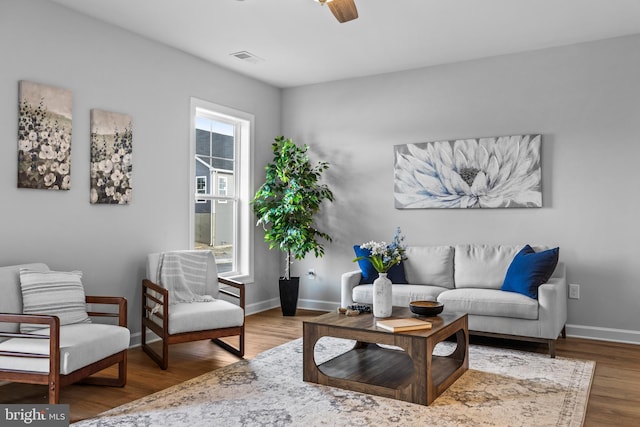 sitting room with hardwood / wood-style floors, ceiling fan, and plenty of natural light