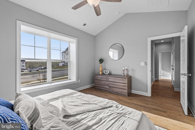 bedroom featuring ceiling fan, wood-type flooring, and vaulted ceiling