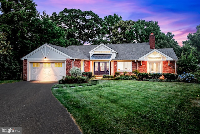 view of front facade with a garage and a lawn