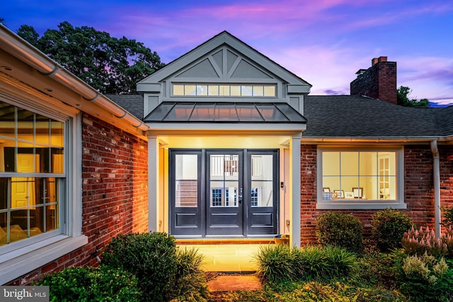 exterior entry at dusk with french doors