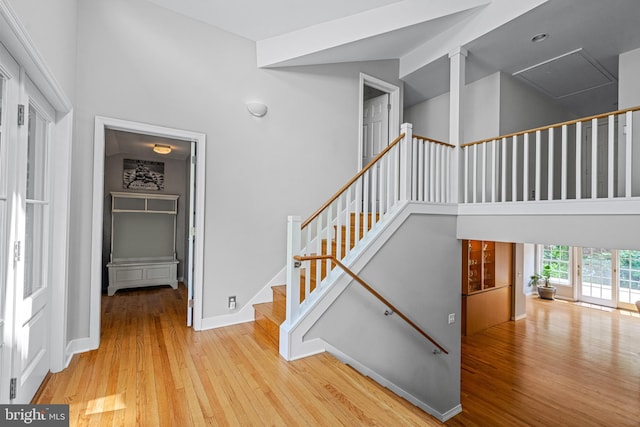 staircase with a high ceiling and light wood-type flooring