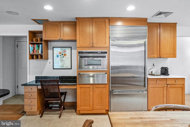 kitchen with stainless steel appliances and light tile patterned floors