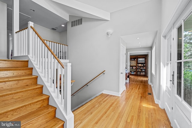 stairway featuring light wood-type flooring