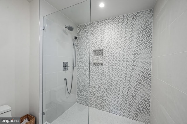 bathroom with walk in shower and toilet