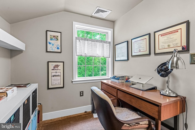 carpeted office space featuring vaulted ceiling