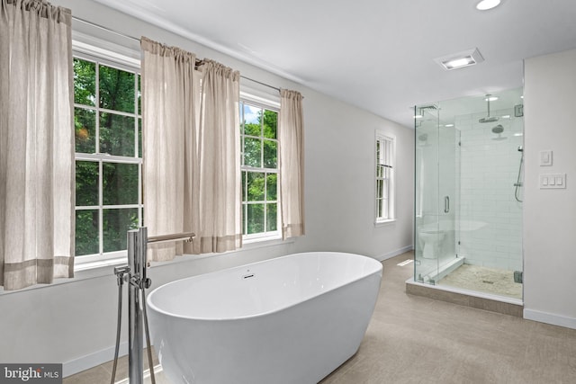 bathroom featuring shower with separate bathtub and tile patterned floors