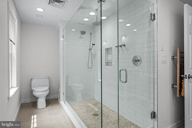 bathroom with tile patterned floors, an enclosed shower, and toilet