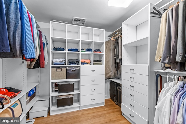 spacious closet featuring light hardwood / wood-style floors