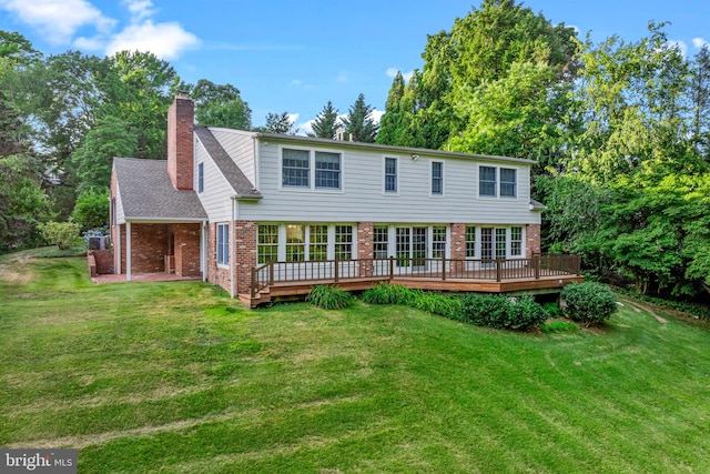 exterior space with a deck and a front lawn