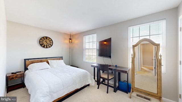 bedroom featuring light carpet