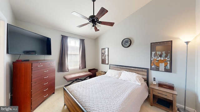 carpeted bedroom with ceiling fan and vaulted ceiling