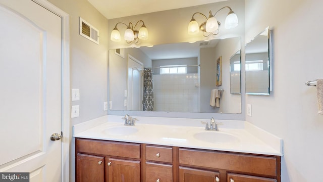 bathroom with a shower with curtain and vanity