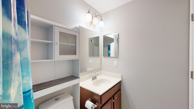 bathroom featuring vanity and toilet