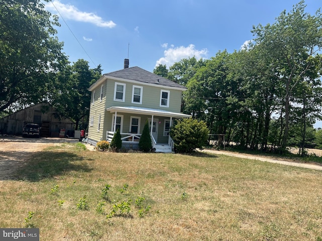 view of front facade featuring a front yard and a porch