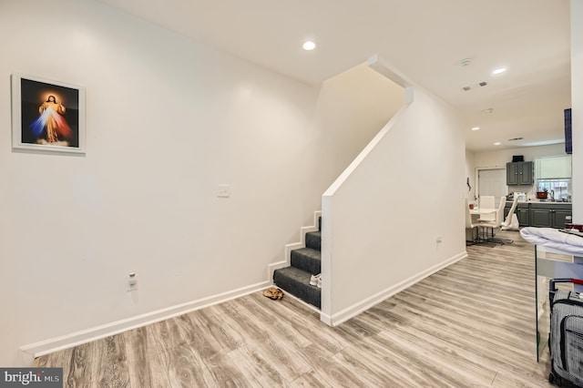 stairs featuring wood-type flooring