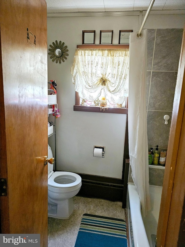 bathroom featuring toilet and shower / bathtub combination with curtain