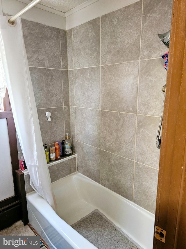 bathroom featuring shower / bathtub combination with curtain