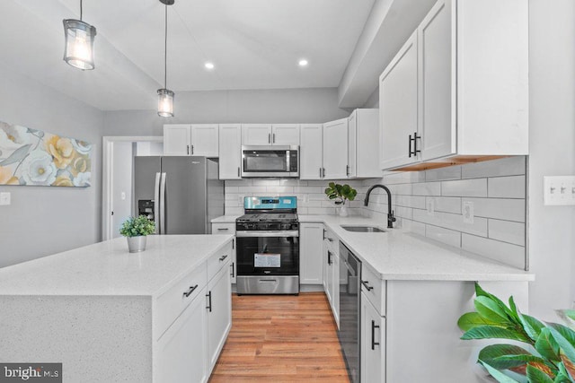 kitchen featuring white cabinetry, sink, appliances with stainless steel finishes, and tasteful backsplash