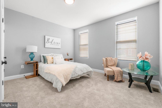 bedroom featuring light carpet