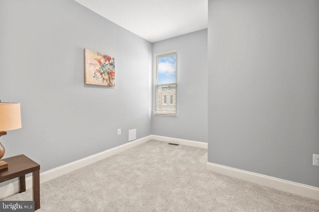 empty room featuring light colored carpet