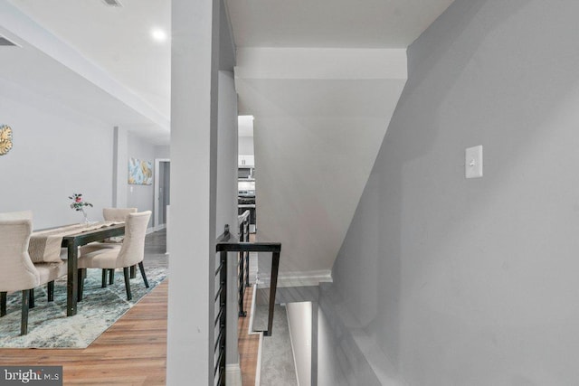 staircase with hardwood / wood-style floors