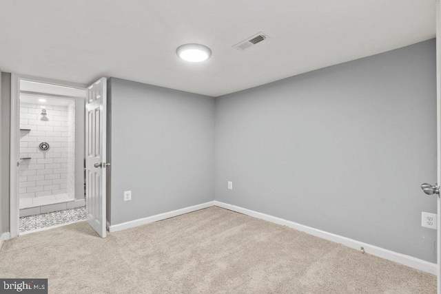 empty room featuring light carpet