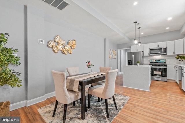 dining space with light hardwood / wood-style flooring