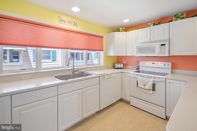 kitchen with white cabinetry, sink, white appliances, and light tile patterned floors