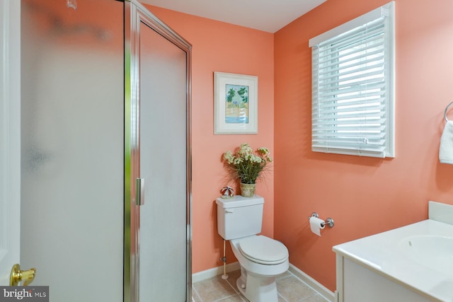 bathroom featuring vanity, toilet, a shower with door, and tile patterned flooring