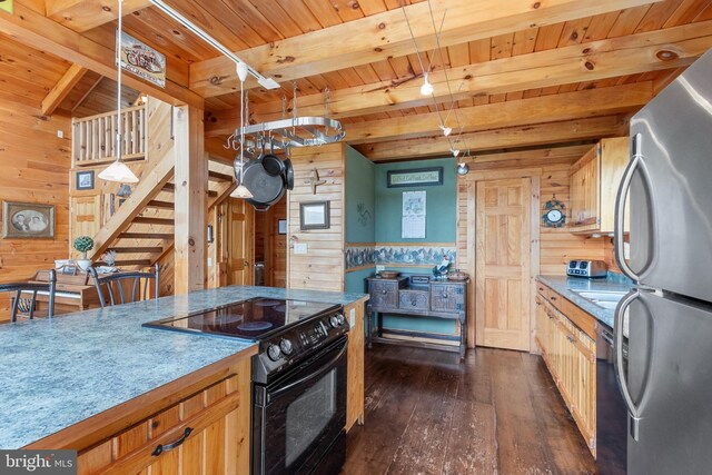 kitchen with dark wood-type flooring, wooden walls, black / electric stove, and decorative light fixtures