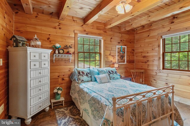 bedroom with multiple windows, wooden ceiling, and beam ceiling