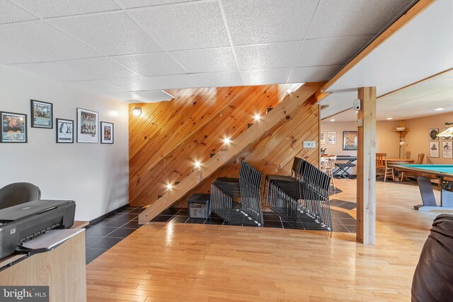 interior space featuring wood-type flooring, pool table, and a drop ceiling