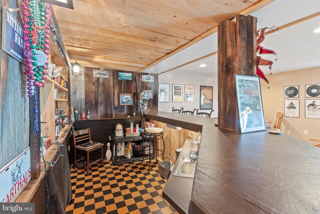 interior space featuring wood walls and dark brown cabinets