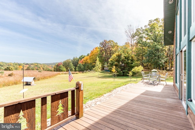 wooden terrace with a yard