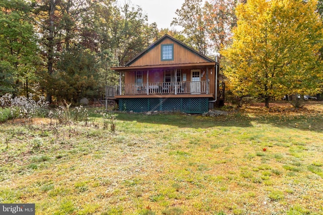 rear view of property with a porch and a lawn