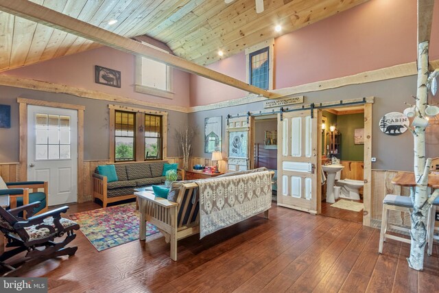 living room with high vaulted ceiling, wooden ceiling, wood-type flooring, and a barn door