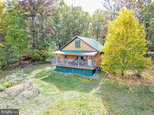 rear view of property with a yard and a deck