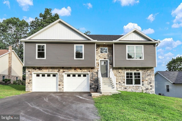 raised ranch featuring a front yard and a garage