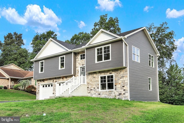 raised ranch with a garage and a front lawn