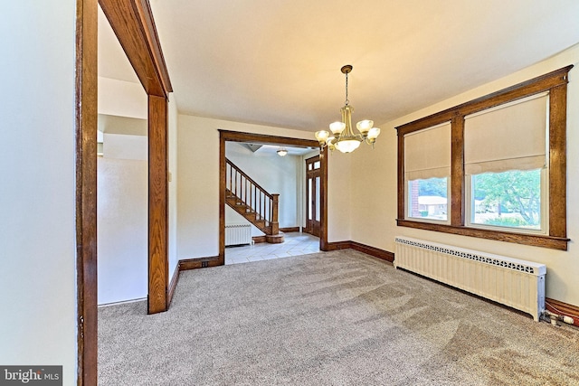 unfurnished dining area with stairs, carpet floors, a notable chandelier, and radiator