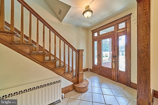 tiled foyer featuring radiator