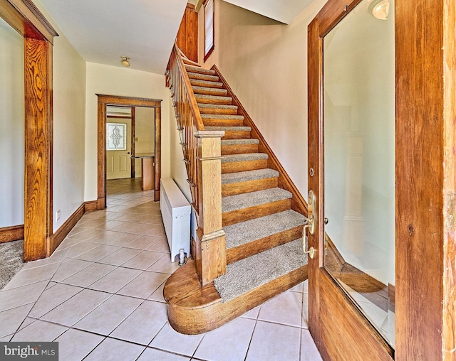 staircase with tile patterned flooring and baseboards