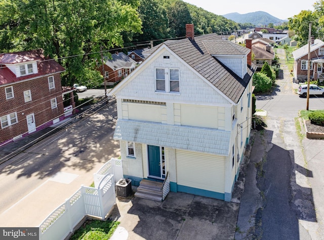 exterior space featuring a mountain view and central AC unit